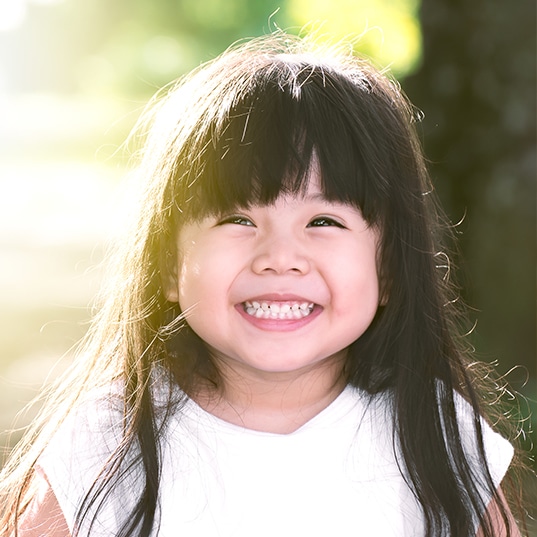 adorable little girl with bangs smiling
